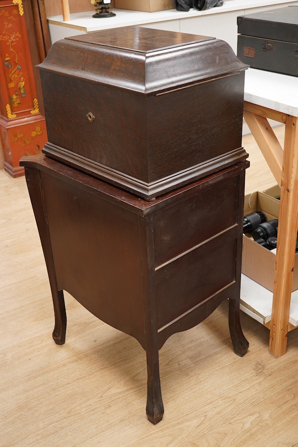 Two gramophone players; an oak cased HMV tabletop gramophone on a similar style mahogany gramophone record stand, height of stand 72.5cm, together with a May-Fair Deluxe Model portable gramophone player. Condition - poor